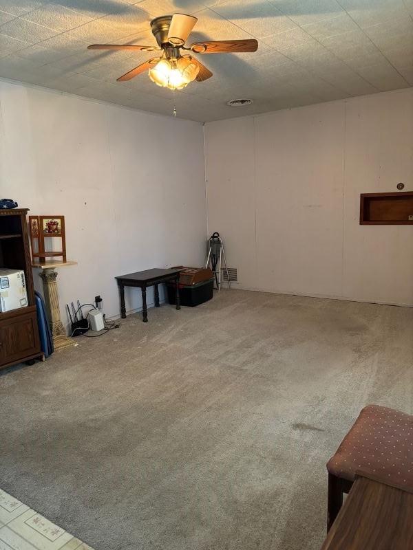 1228 Cypress St, Baytown, TX 77520 - unfurnished living room featuring carpet and a ceiling fan