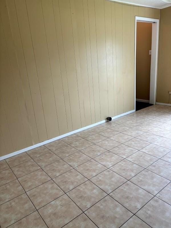 1228 Cypress St, Baytown, TX 77520 - spare room with wood walls