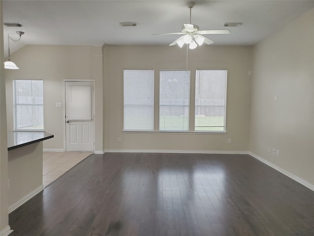 unfurnished living room featuring baseboards, visible vents, wood finished floors, and a ceiling fan