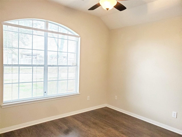 empty room with dark wood-type flooring, plenty of natural light, baseboards, and a ceiling fan