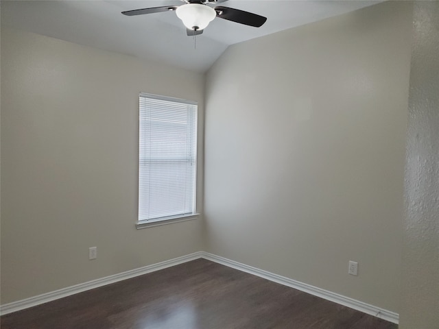 unfurnished room featuring vaulted ceiling, dark wood finished floors, baseboards, and ceiling fan