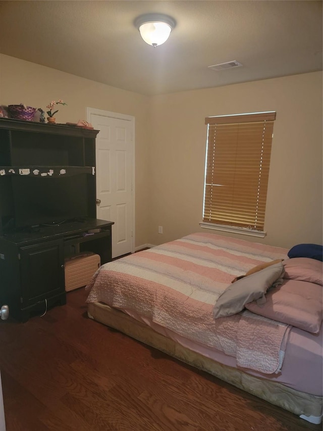 bedroom with visible vents and wood finished floors