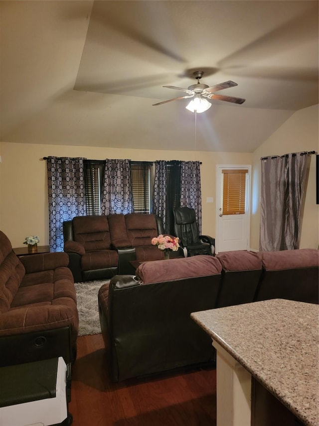 living room with dark wood-type flooring, lofted ceiling, and a ceiling fan