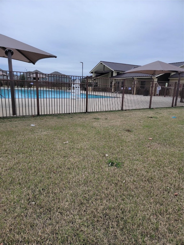 pool featuring a yard and fence