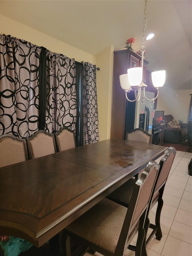 dining space featuring light tile patterned floors and a chandelier