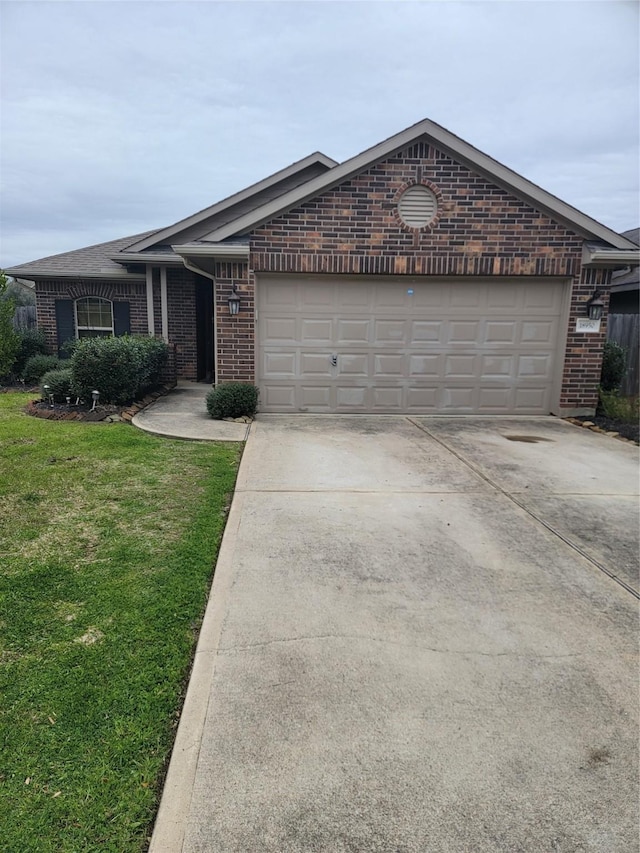 ranch-style house with a garage, driveway, brick siding, and a front yard