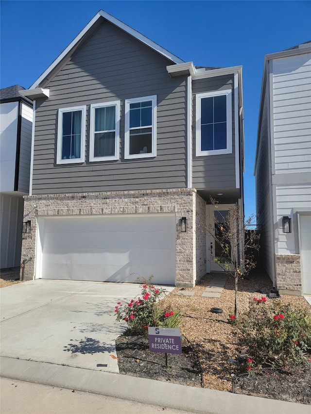 view of front of property featuring concrete driveway, brick siding, and an attached garage