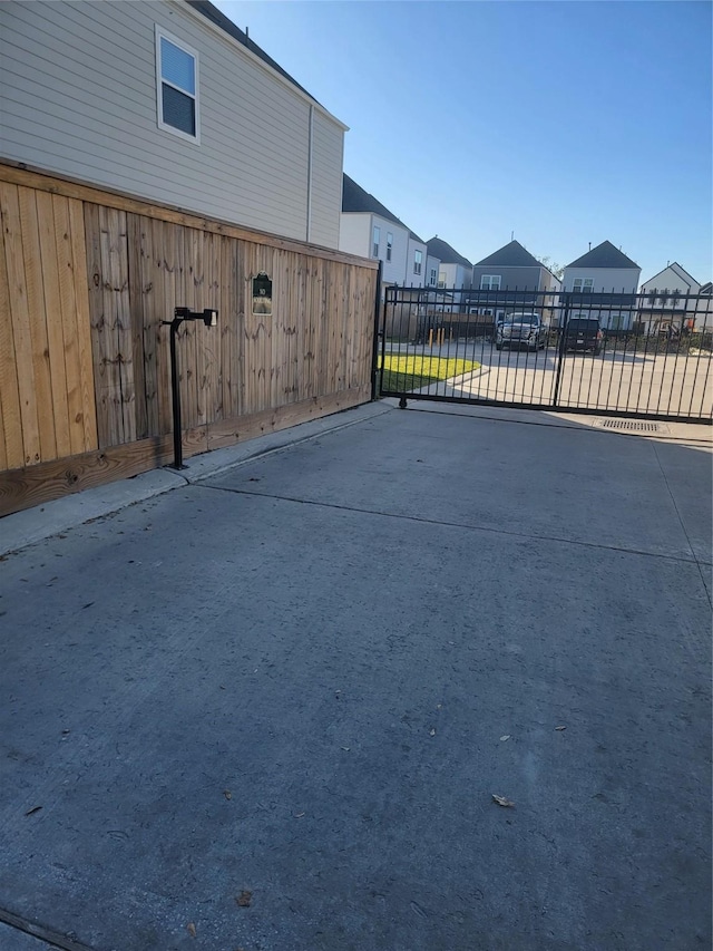 view of gate with a residential view and fence