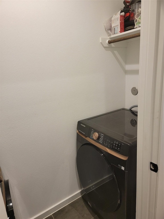 laundry room with washer / dryer, tile patterned flooring, laundry area, and baseboards