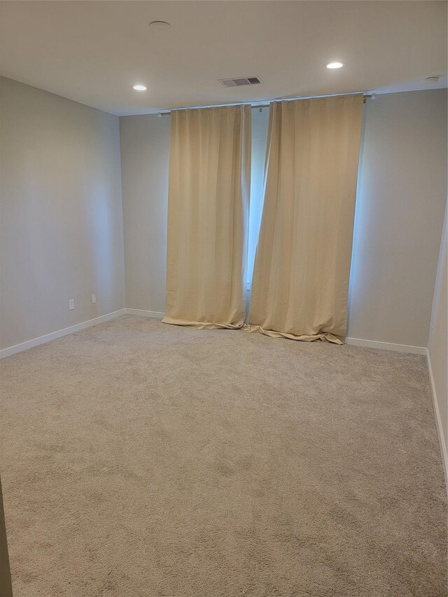 carpeted empty room with recessed lighting, visible vents, and baseboards