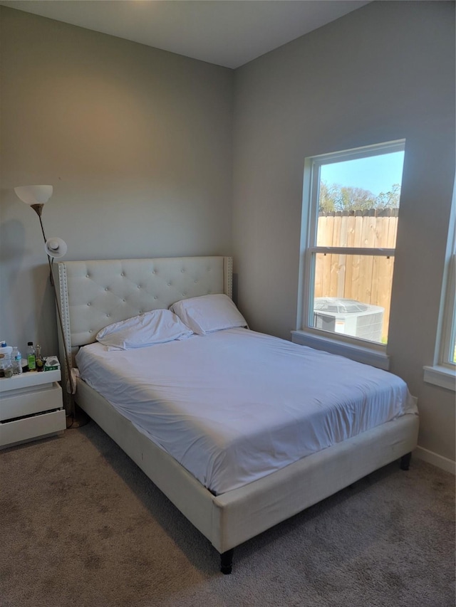 bedroom featuring carpet and baseboards