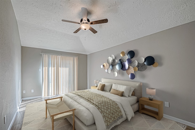 bedroom with carpet, a ceiling fan, vaulted ceiling, a textured ceiling, and baseboards