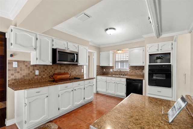 kitchen featuring visible vents, white cabinets, a sink, black appliances, and backsplash