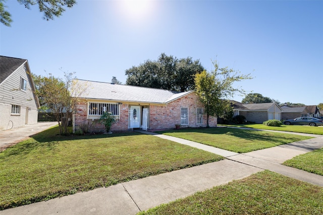 ranch-style home featuring brick siding and a front yard