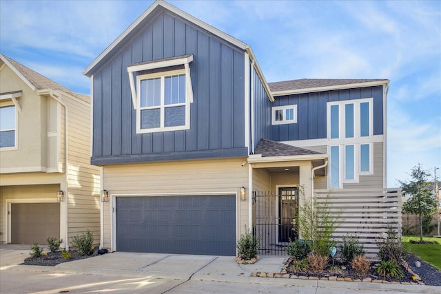 view of front of property with a garage, driveway, a shingled roof, and board and batten siding