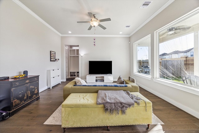 living room with ornamental molding, visible vents, and baseboards