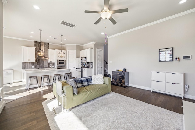 living room with visible vents, dark wood finished floors, stairway, and baseboards