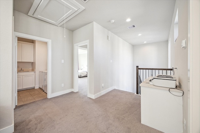 corridor featuring recessed lighting, light colored carpet, visible vents, attic access, and an upstairs landing