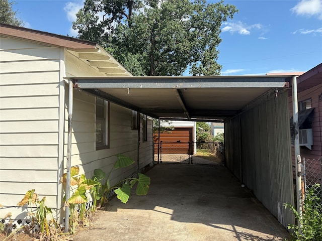 view of parking featuring driveway, fence, and a carport