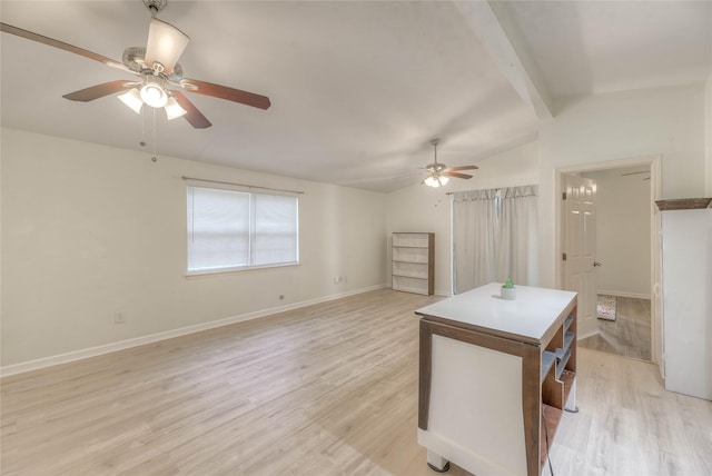 interior space featuring light wood-type flooring, ceiling fan, lofted ceiling with beams, and baseboards