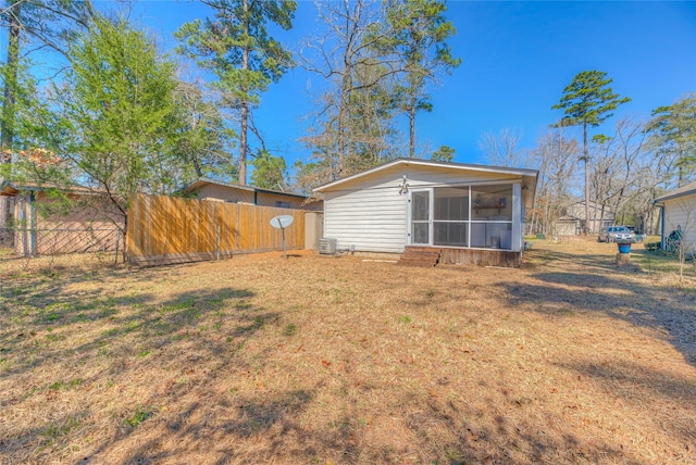 view of yard featuring fence and a sunroom