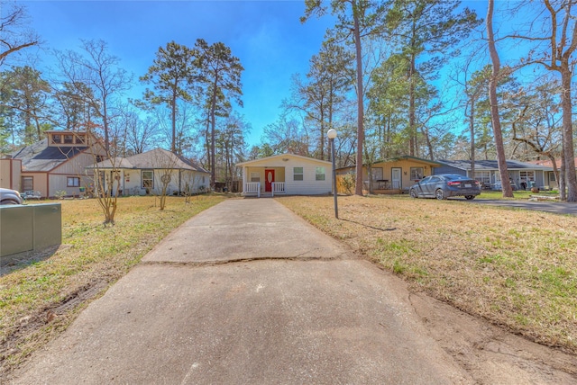 view of front facade featuring a front yard, driveway, and a residential view