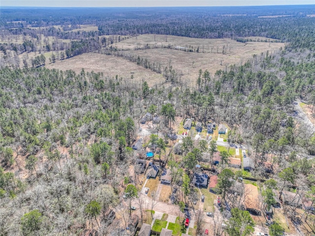 birds eye view of property featuring a view of trees