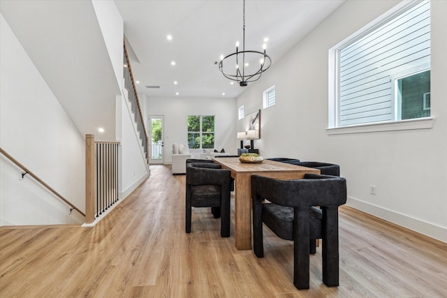 dining space with baseboards, stairway, light wood-type flooring, a notable chandelier, and recessed lighting