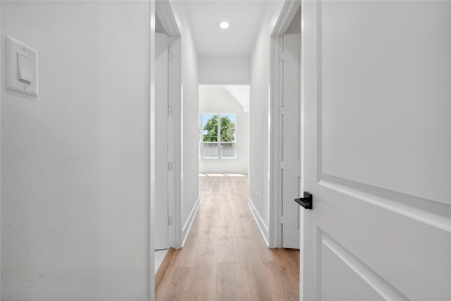 hallway with light wood-style floors, recessed lighting, and baseboards