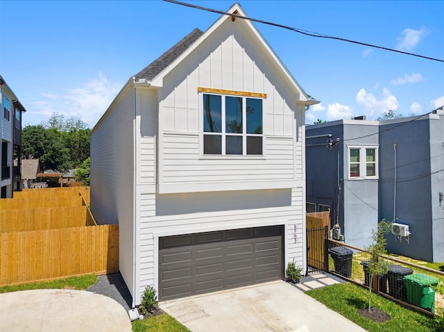 view of front facade with central AC unit, concrete driveway, an attached garage, fence, and board and batten siding