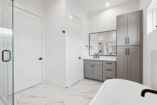 bathroom featuring marble finish floor, recessed lighting, a stall shower, vanity, and a freestanding tub