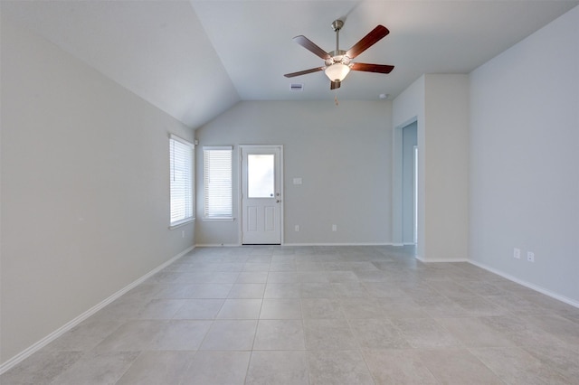 empty room with ceiling fan, light tile patterned flooring, visible vents, and baseboards