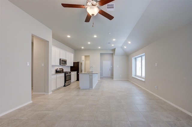 kitchen with a center island with sink, stainless steel appliances, visible vents, open floor plan, and white cabinetry