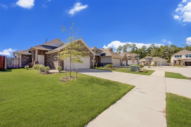 view of front of home featuring driveway, a residential view, an attached garage, fence, and a front yard