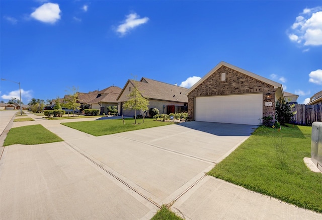 view of front of property featuring driveway, a garage, brick siding, fence, and a front yard