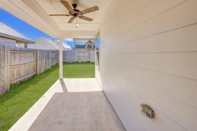 view of patio featuring ceiling fan and fence