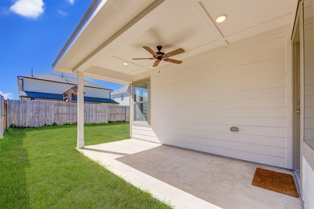 view of yard with fence private yard, a ceiling fan, and a patio