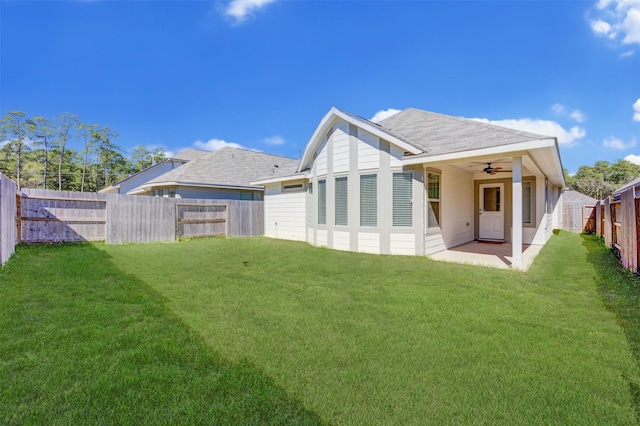 back of property with a yard, a patio area, a fenced backyard, and a ceiling fan