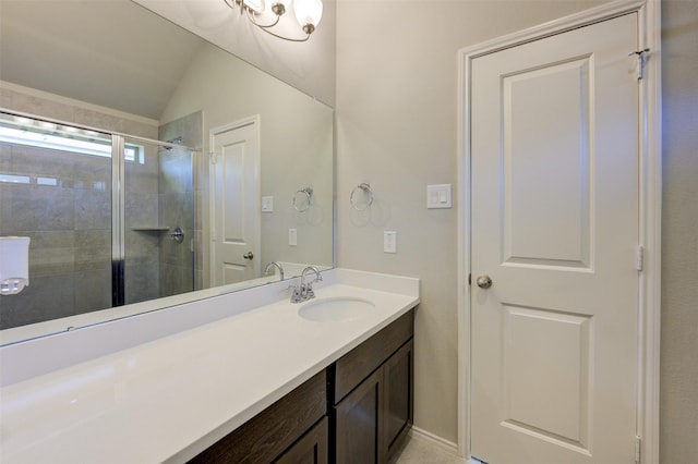 bathroom with lofted ceiling, a shower stall, and vanity