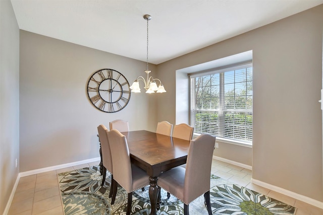 dining room with light tile patterned floors, baseboards, and an inviting chandelier