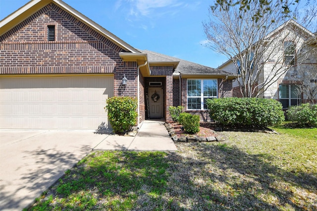 view of front of property featuring a garage, driveway, a front yard, and brick siding