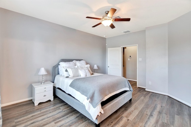 bedroom featuring a ceiling fan, light wood-type flooring, visible vents, and baseboards