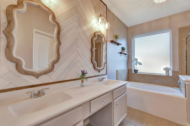 full bath featuring double vanity, a garden tub, a sink, and tile patterned floors