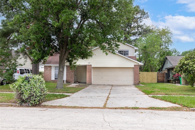 view of front of property with driveway, brick siding, an attached garage, and fence