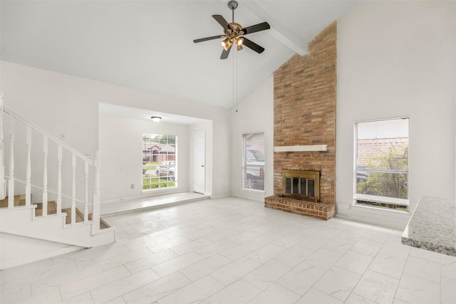 unfurnished living room featuring high vaulted ceiling, stairs, marble finish floor, a brick fireplace, and beamed ceiling