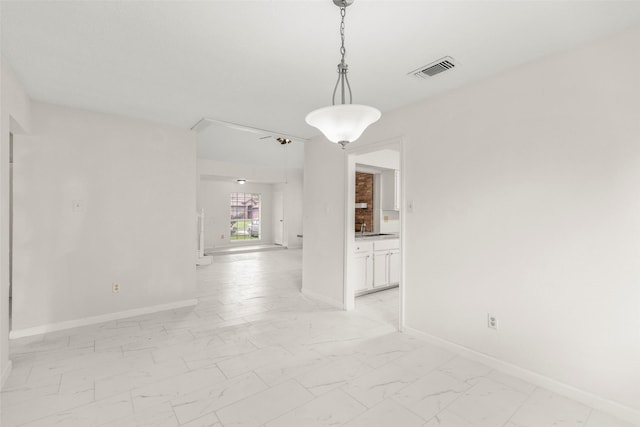 unfurnished dining area featuring marble finish floor, visible vents, and baseboards