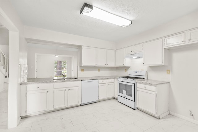 kitchen featuring under cabinet range hood, white appliances, a sink, white cabinets, and marble finish floor