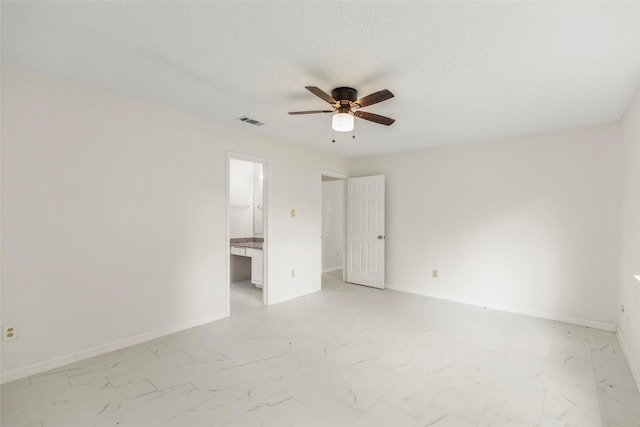 unfurnished bedroom featuring marble finish floor, a ceiling fan, visible vents, and baseboards