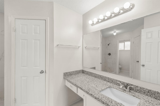 full bathroom with a shower, a textured ceiling, toilet, and vanity