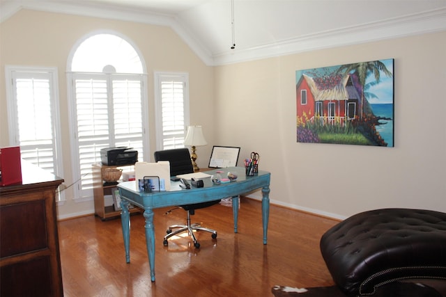 office area with baseboards, lofted ceiling, wood finished floors, and ornamental molding